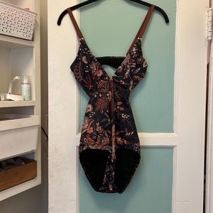 Patterned swimsuit. Bought and worn for a vacation, then cleaned and shelved